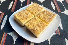 four pieces of cake sitting on top of a white plate