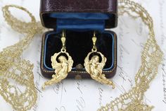 Angel Earrings, Cherub Celestial Earrings, Gold Dangle Earrings, To my Daughter, Godmother Gift, Coquette Jewellery, 30th 50th Birthday One of our own designs, a stunning pair of Vintage Gold Drop Earrings with Golden Winged Angels in a Victorian Style. These beauties have an aged brass lever back ear wire at the top, and hanging beneath are magnificent angels in oxidised brass.   The metal has a wonderful aged patina.  Lovely as a gift or to treat yourself.   We send all our jewellery wrapped in tissue paper with pretty sticker motifs.  The box in the photos is for display. Shipping - if you'd like the option to track your parcel, please choose the shipping upgrade at checkout.  It isn't much more expensive, however offers peace of mind and includes insurance.  The standard / free despatc Coquette Jewellery, Celestial Earrings, Angel Earrings, Godmother Gifts, Gold Dangle Earrings, Christian Jewelry, Gold Earrings Dangle, Gold Drop Earrings, Godmother