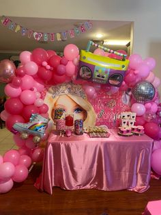 a birthday party with pink balloons and decorations