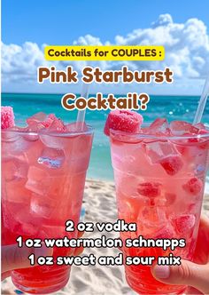 two pink cocktails with strawberries on the beach