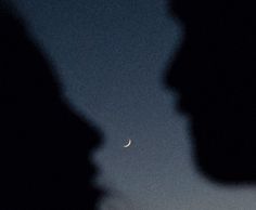 two people are looking at the moon in the sky with one person's face to the left