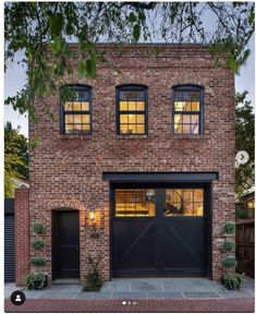 a brick house with two garage doors and windows