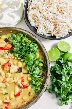 an overhead view of a bowl of food with rice and cilantro on the side