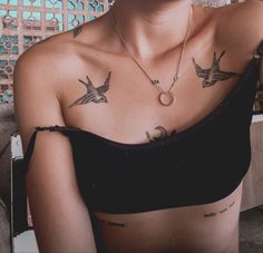 a woman with two birds on her chest