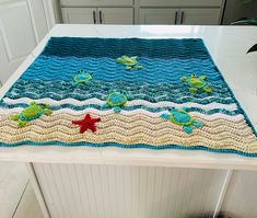 a crocheted placemat with sea turtles and starfish