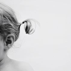 black and white photograph of a woman's head with hair in a pony tail