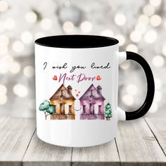 a coffee mug with two houses and the words, i want you loved not down