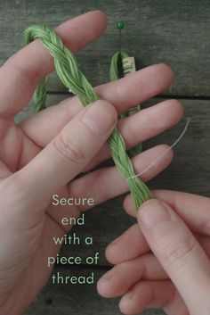 two hands holding yarn and thread with the words secure end with a piece of thread