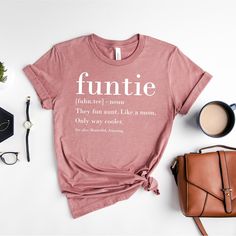 Funtie Definition Shirt, Auntie Shirts, Aunt T Shirt, Mother's Day T-Shirt, Gift For Aunt, Aunt Birthday Shirt, Funny Aunt Tee, Aunt Gift ZW How to Order?  1-Choose your t-shirt color, 2- Choose your size, 3- Select the quantity, 4- Click Add to Cart.  Production and shipping: * 100% airlume combed and ring-spun cotton, 32 singles 4.2 oz. * Solid colors are %100 cotton * Heathers are %52 cotton %48 polyester * Athletic Heather is combed and ring-spun cotton, 10% polyester * Seamless collar * Hea Fun Shirt With Funny Print For Gift, Funny Print Shirt As Gift, Funny Text Print Shirt For Spring, Summer Slogan Top As Gift, Fun Short Sleeve Shirt For Mother's Day, Casual Tops With Funny Text For Gifts, Fun Short Sleeve Tops For Gifts, Fun Letter Print Tops For Gifts, Fun Tops With Letter Print For Gifts