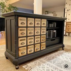 a cabinet with many drawers on top of it in a living room next to a rug