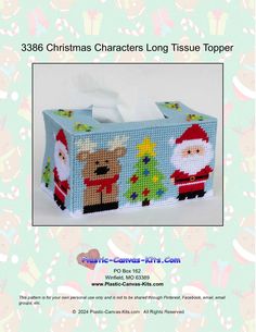 a christmas themed tissue box with santa claus and reindeers on it, in the middle of