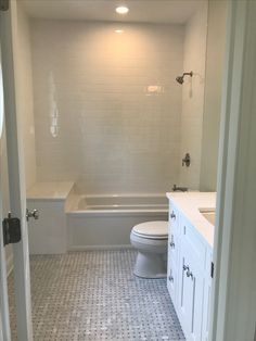 a bathroom with a toilet, sink and bathtub