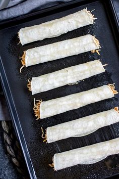 four pieces of bread are on a baking sheet, ready to be baked in the oven