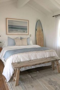 a bedroom with a surfboard on the wall and a bench in front of it