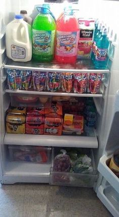 an open refrigerator filled with lots of different types of drinks and snacks on the shelves