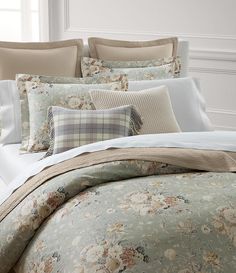 the comforter is made up with many different types of flowers and plaids on it