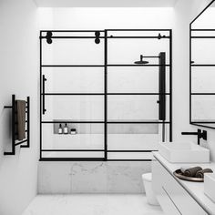 a white bathroom with two sinks and large mirrors on the wall next to each other