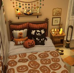 a bedroom decorated for halloween with pumpkins and jack - o'- lantern pillows