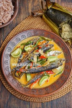 a plate with some fish on it next to other foods