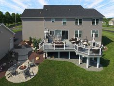 an aerial view of a large house with patio and decking in the front yard