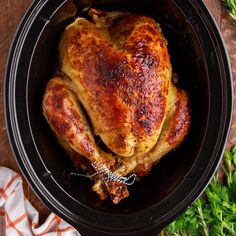 a cooked chicken in a slow cooker