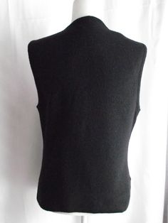 "This beautiful embroidered vest can go from casual to semi-formal with just a few quick changes. Made of a jet black wool, heavy thread, similar to cording forms the designs of flowers and foliage for wearable art. Small side seam open vent gives you more space when sitting. V-neck design with a button front makes it easy to grab and go. No stains, snags or damage. Some light pilling, typical of wool. Please view all my photos. This a Dry Clean Only Garment. Please view all my actual measuremen Fitted V-neck Winter Vest, Fitted V-neck Vest For Winter, Fitted Vest For Winter Layering, Black Fitted Sweater Vest, Fitted Black Classic Sweater Vest, Classic Fitted Black Sweater Vest, Black Fitted Classic Sweater Vest, Elegant Embroidered Fitted Vest, Elegant Fitted Embroidered Vest