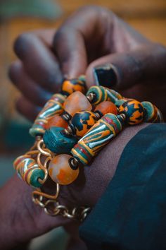 The hand painted krobo beads are famous for their intrigueing color combinations.We created this beautiful bracelet with antique Turquoise Hebron beads,recycled Gas beads and ceramic Krobo beads. This bracelet is 7.5 inches long with extra links to allow for adjustment.Its width spans to almost 2 inches and is light on the wrist. We use art as a vehicle to create sustainable income for the young women we work with. Thank you for visiting our store! Xoxoxo Atiamuga Chunky Bracelets Bohemian, Cheap Handmade Statement Stretch Bracelet, Luxury Multicolor Wooden Beads Jewelry, Cheap Orange Bohemian Beaded Bracelets, Affordable Bohemian Wooden Beads Stretch Bracelet, Cheap Orange Bohemian Stretch Bracelet, Affordable Large Beads Hippie Jewelry, Luxury Multicolor Jewelry With Wooden Beads, Affordable Statement Jewelry With Wooden Beads