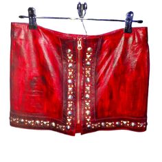 Stand Out In This Stunning, Rare Custom Robin's Jean Skirt! Crafted From Our Luxurious Oxblood Grain Dyed Lambskin Leather, This Piece Exudes Edgy Elegance With Its Striking Studded Details. Perfectly Tailored, It’s A Size 27 And Boasts A Flirty 12½" Length, Making It Ideal For Both Day And Night Ensembles. Zip Up And Step Out In Style! Size: 27 Color: Oxblood Material: Lambskin Leather Fast Shipping & Handled With Care! Dm To Claim Or For More Details! #Robinsjean #Leatherskirt #Studdedfashion #Designerwear #Unisex Edgy Elegance, Jean Skirts, Robin Jeans, Jean Skirt, Day And Night, Designer Wear, Lambskin Leather, Leather Skirt, Zip Ups