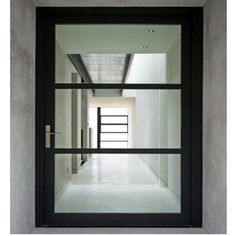 an empty hallway with glass doors and white walls