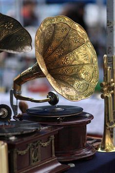 an old phonograph sitting on top of a table next to other musical instruments