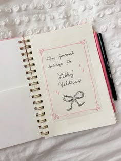 an open notebook with writing on it next to a pen