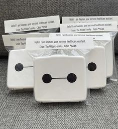 four pieces of white plastic with black dots on them sitting in front of each other