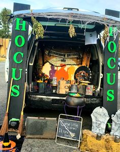 the back of a van with halloween decorations on it's trunk and sign that says hoccupus