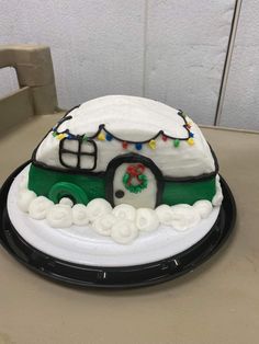 there is a cake that looks like a car with lights on it and snow around the roof