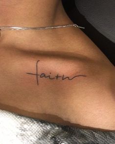 a woman with a tattoo on her stomach saying faith