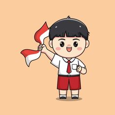 a boy holding a flag in his hand and wearing a shirt with red shorts on it