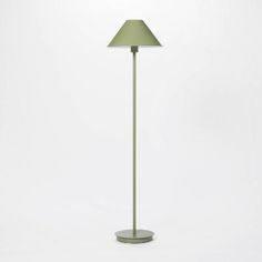 a green floor lamp on a white background