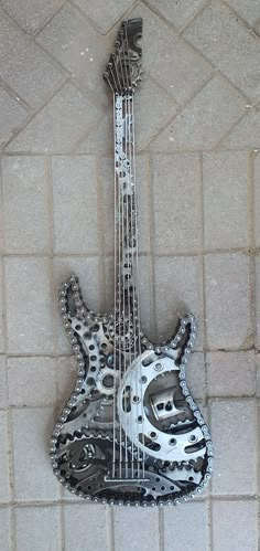 a metal guitar sitting on top of a tiled floor