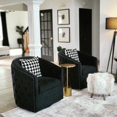 two black and white chairs in a living room