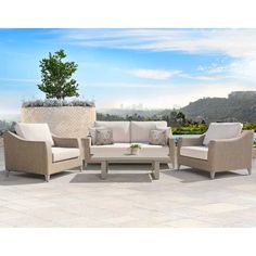 an outdoor patio furniture set with beige cushions and white wicker sofas, coffee table and planter