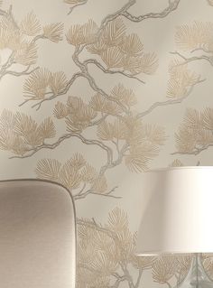 the wallpaper in this living room is gold and white, with branches on it