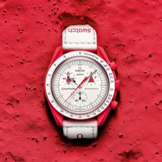 The Swatch X Omega Bioceramic Moonswatch Mission To Mars (So33r100) Pays Tribute To Our Planetary Neighbor By Showcasing Bright Red Tones Contrasted With A White Velcro Strap. Both Subdials Are Shaped Like A Rocket Shape, Perhaps In Reference To Humanity's Curiosity And Long-Time Goal Of Reaching Mars. The Swatch X Omega Moonswatch Mission To Mars (So33r100) Features Quartz Movement, Superluminova Hours, Minutes, And Second Hands, And Is 3 Bar Water Resistant. Mission To Mercury, Swatch Store, Omega X Swatch, Omega Speedmaster Moonwatch, Mens Designer Watches, Moon Watch, Moon Missions, Mission To Mars, Couple Watch