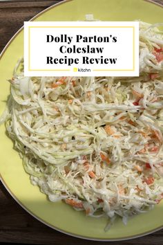 a yellow plate topped with coleslaw slaw and carrots next to a wooden table