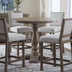 a dining room table with four chairs around it