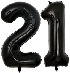 the number twenty two is made out of black foil balloons and sits in front of a white background