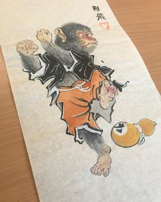 a drawing of a monkey with an orange ball in his hand and chinese characters on it