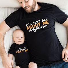 a man laying on top of a bed next to a baby