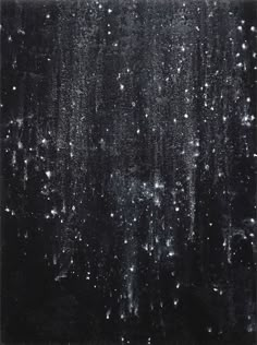 black and white photograph of rain falling on the window with lots of bubbles in it