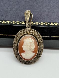 This is a beautiful vintage Theodor Fahrner sterling silver gilt cameo pendant. It is marked "TF" in a circle and "925". The pendant is in very good vintage condition with age and use related wear, there is tarnishing to the metal. The pendant measures approximately 1 3/8" by 3/4". Monogrammed Cufflinks, Angel Bracelet, Puffy Heart Charms, Cameo Pendant, Puffy Heart, A Circle, Flower Necklace, Vintage Sterling Silver, Heart Charm