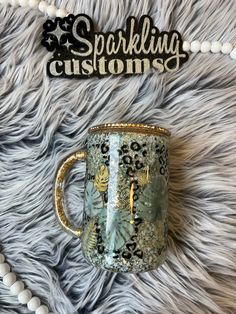 a coffee mug sitting on top of a fur covered floor next to a sign that says sparkling customs